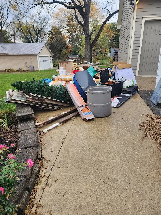 Dumpster being loaded with debris for Estate Cleanout Dumpster Rental in Hebron